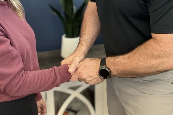 Chiropractor Wilmington NC Rhett King Adjusting Patient Hand